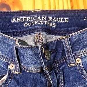 Distressed stretch blue jeans by American Eagle, size 4